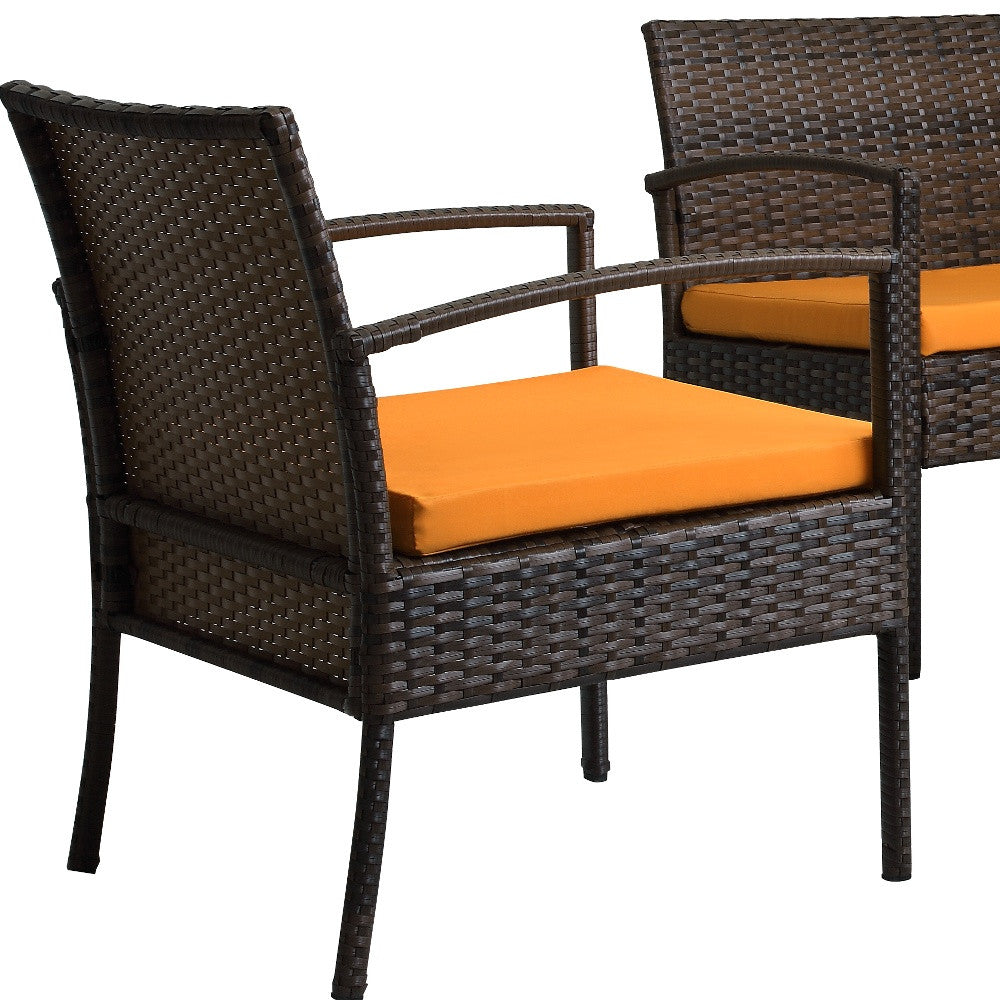 Four Piece Outdoor Brown Wicker Sofa Seating Group with Orange Cushions