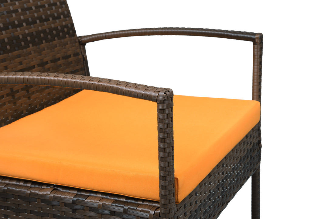 Four Piece Outdoor Brown Wicker Sofa Seating Group with Orange Cushions